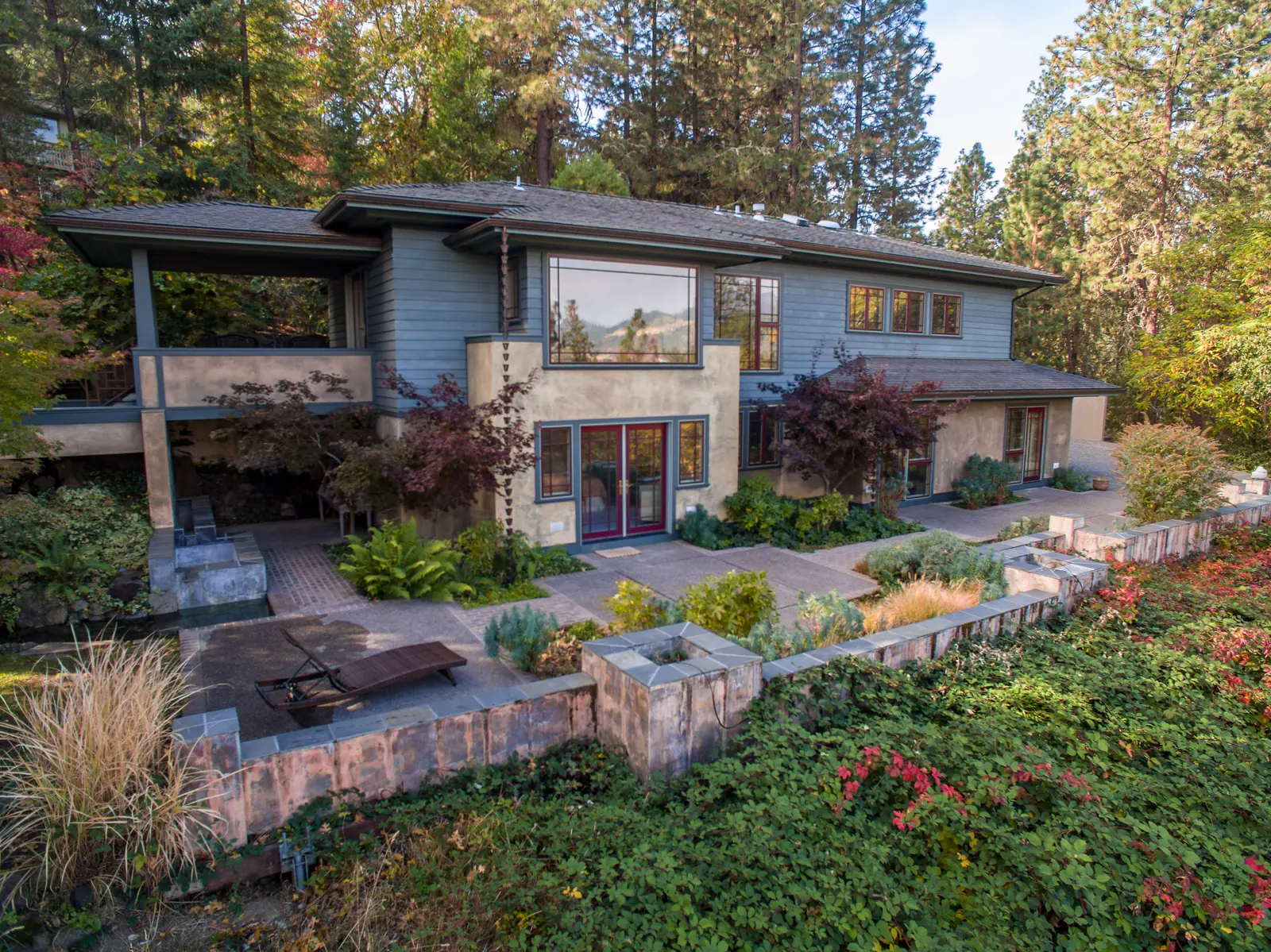 A well-maintained home surrounded by layered professional landscaping